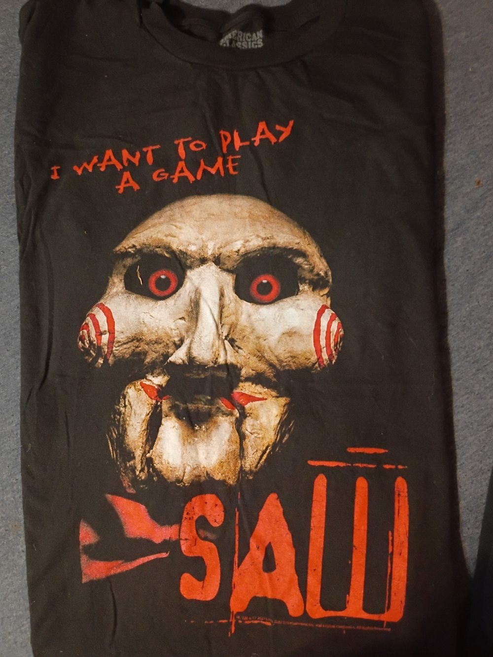 Black SAW Graphic T-Shirt with Red Accents - Horror Game Design